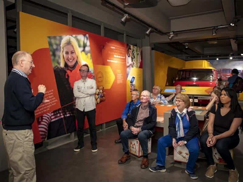 A group of visitors watching a BSL tour guide.