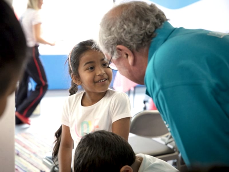 A volunteer and child at a schools session in The Postal Museum.