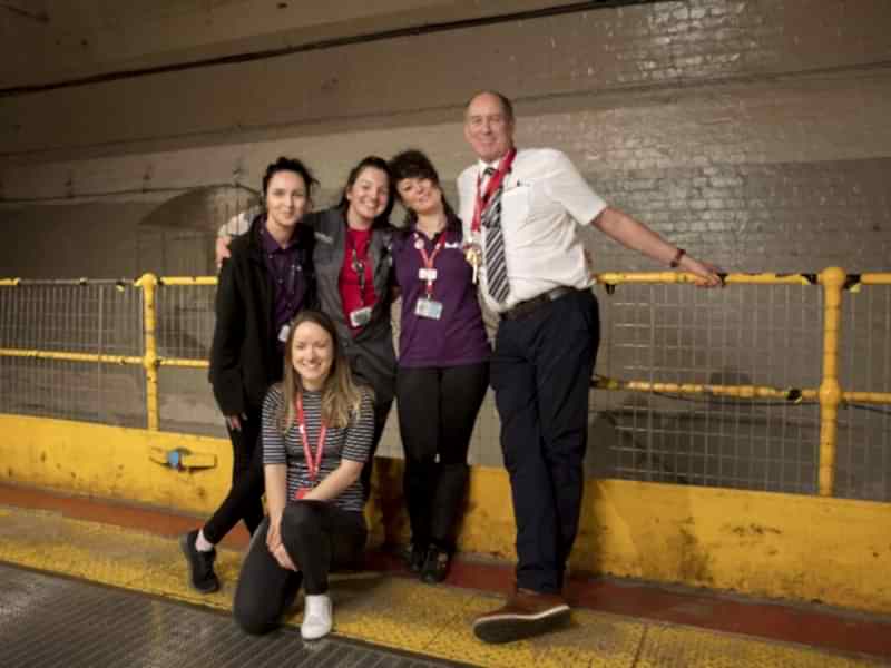 Five members from our Visitor Experience team posing for a photograph