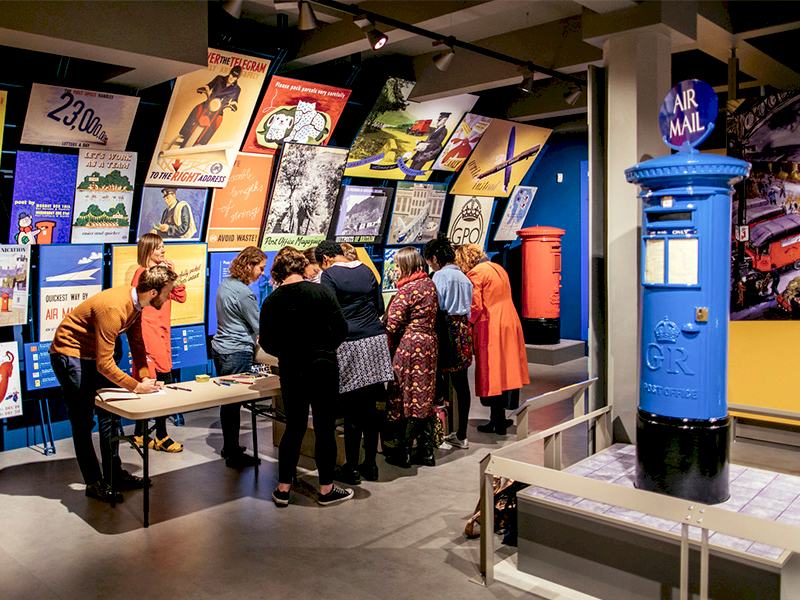 A group of people attend a tour at the museum