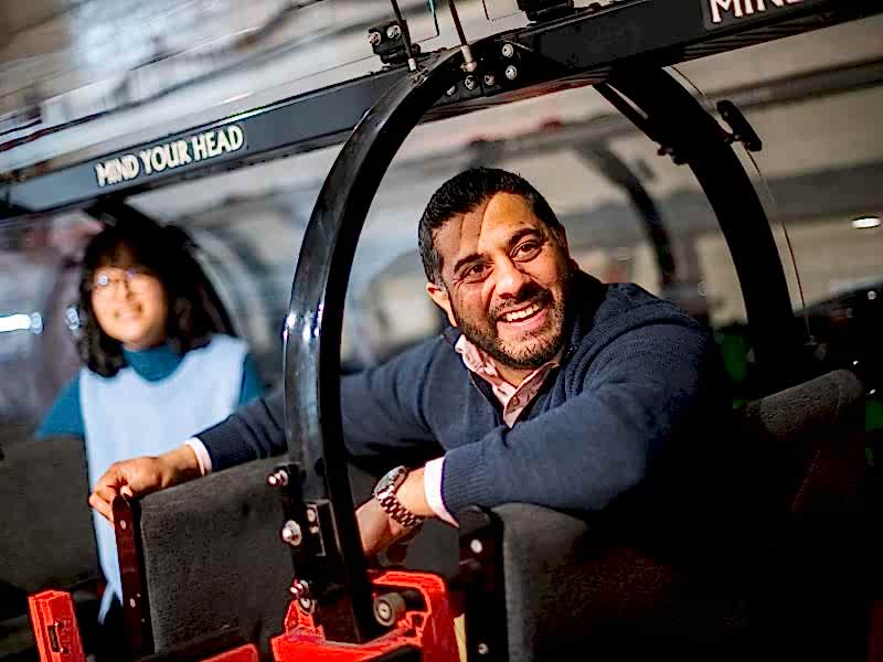 This man. attending The Postal Museum as part of the group, is dressed smart-casually and looks happy and relaxed.